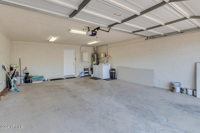 garage with water heater, a garage door opener, and independent washer and dryer