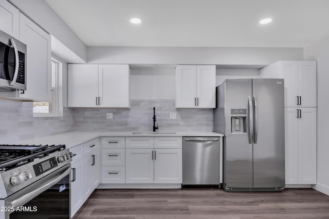 119 W Silver Reef Rd, Casa Grande, AZ 85122 - kitchen with appliances with stainless steel finishes, a sink, white cabinetry, light countertops, and backsplash