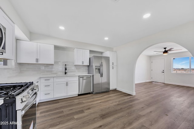 119 W Silver Reef Rd, Casa Grande, AZ 85122 - kitchen with stainless steel appliances, a sink, arched walkways, ceiling fan, and decorative backsplash