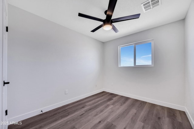 119 W Silver Reef Rd, Casa Grande, AZ 85122 - spare room with dark wood-style flooring, ceiling fan, and baseboards