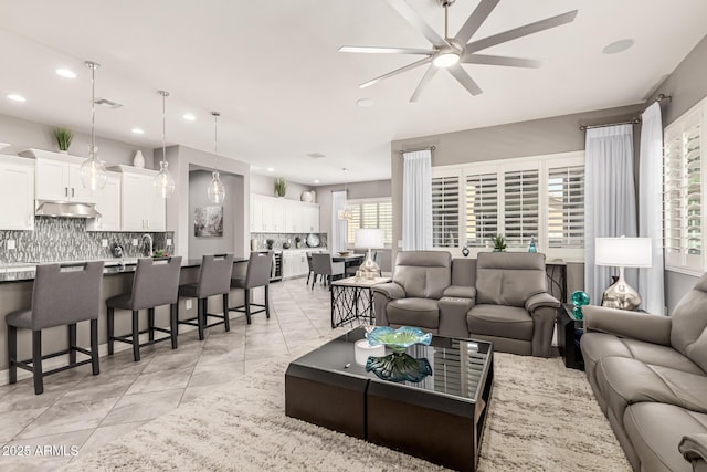 living area featuring light tile patterned flooring, ceiling fan, visible vents, and recessed lighting