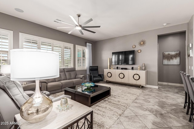 tiled living room with baseboards, ceiling fan, and visible vents