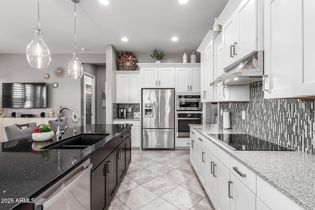 kitchen with white cabinetry, tasteful backsplash, stainless steel appliances, under cabinet range hood, and a sink