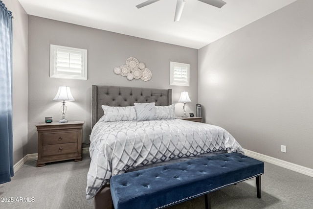 carpeted bedroom featuring baseboards and a ceiling fan