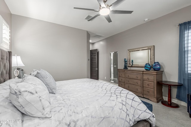 carpeted bedroom with a ceiling fan, baseboards, and visible vents
