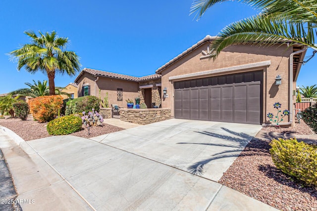 view of front facade featuring a tile roof, concrete driveway, stucco siding, and an attached garage