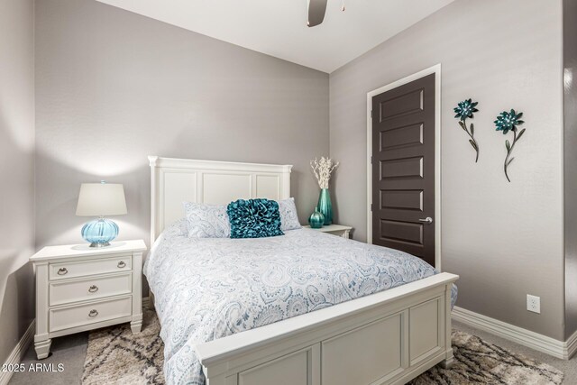 bedroom featuring baseboards, lofted ceiling, and a ceiling fan