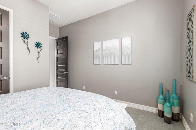carpeted bedroom with baseboards and visible vents
