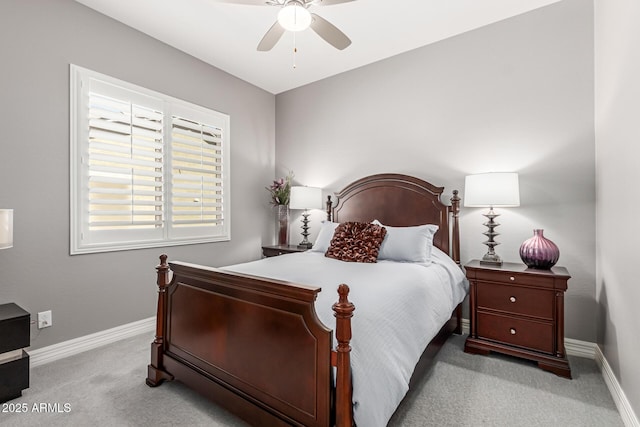 bedroom featuring baseboards, light colored carpet, and ceiling fan