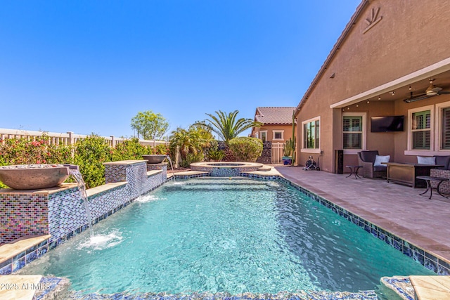 view of swimming pool with an in ground hot tub, a fenced in pool, fence, a patio, and ceiling fan