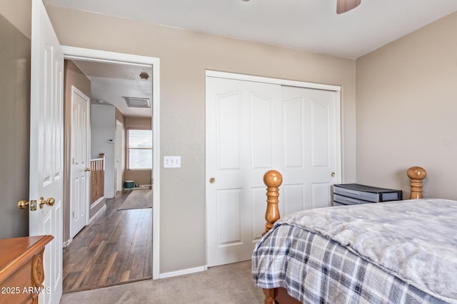 bedroom with a ceiling fan, baseboards, visible vents, a closet, and carpet flooring