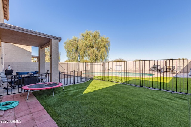 view of yard with a patio area, a fenced in pool, and a fenced backyard