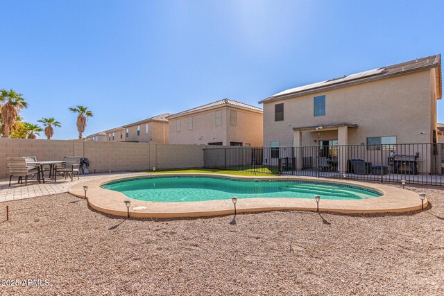 view of pool with a fenced backyard, a fenced in pool, and a patio