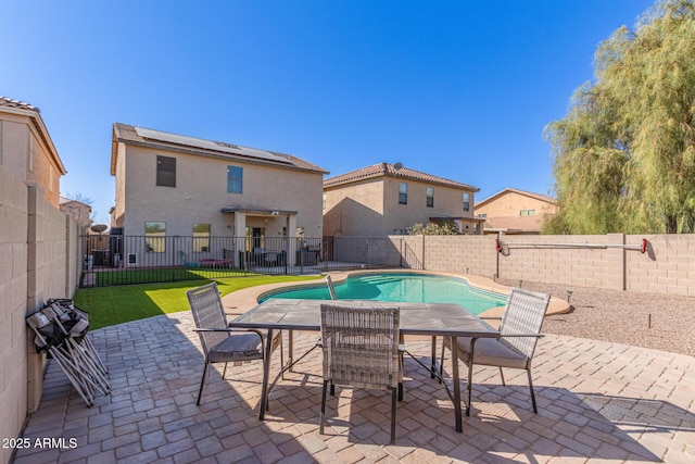 view of swimming pool featuring a fenced in pool, a fenced backyard, and a patio area