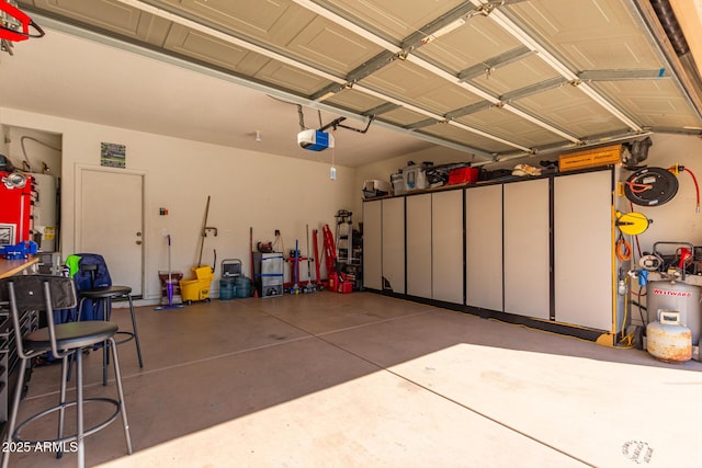garage featuring water heater and a garage door opener