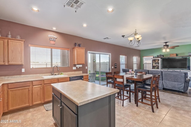 kitchen with light brown cabinets, a sink, light countertops, black dishwasher, and ceiling fan with notable chandelier