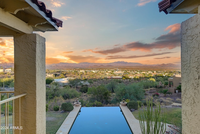 pool at dusk with a mountain view