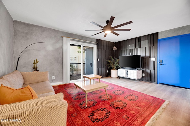 living room with ceiling fan and light hardwood / wood-style flooring