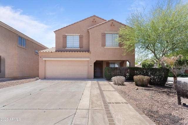 view of front of house with stucco siding, driveway, an attached garage, a tiled roof, and fence