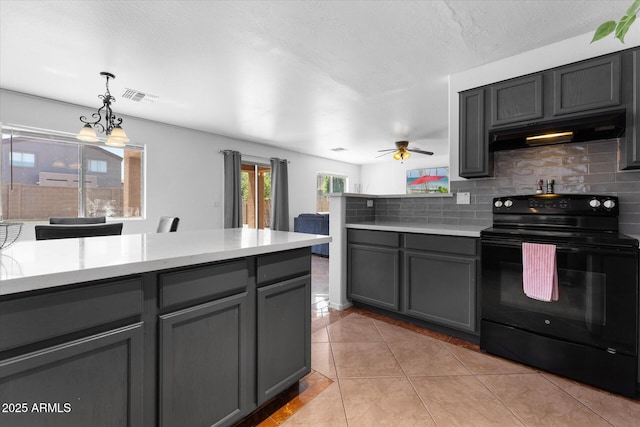 kitchen with tasteful backsplash, visible vents, under cabinet range hood, black electric range, and gray cabinetry