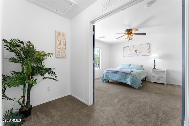 carpeted bedroom featuring baseboards, a ceiling fan, and visible vents