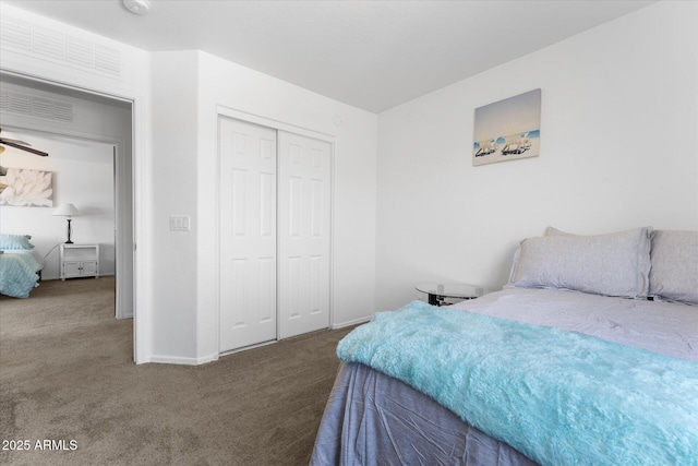 carpeted bedroom featuring a closet and baseboards