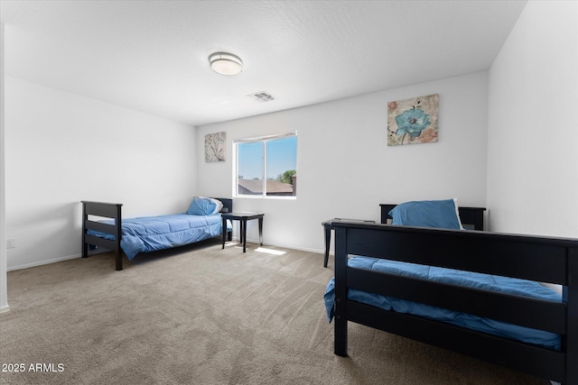 carpeted bedroom with baseboards and visible vents