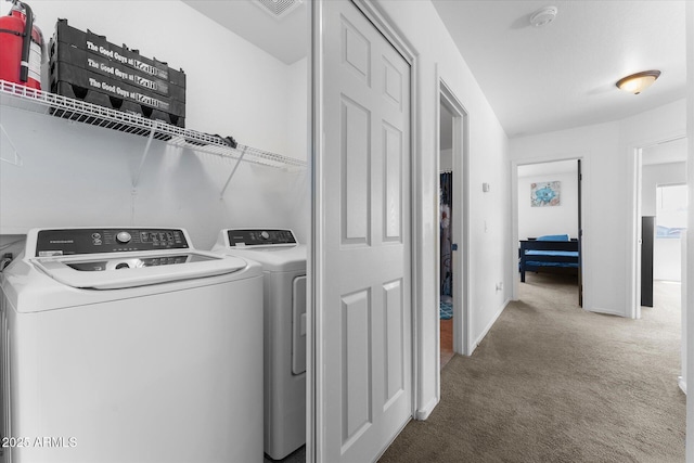 laundry room with baseboards, washing machine and dryer, and carpet