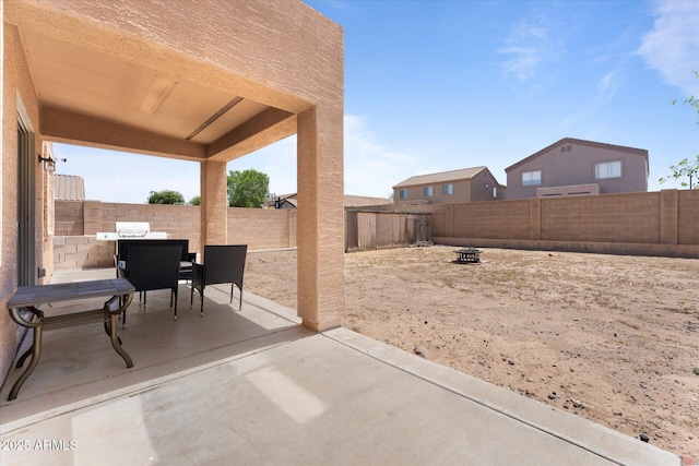 view of patio / terrace with an outdoor fire pit and a fenced backyard