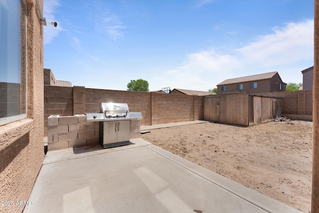 view of patio with grilling area and a fenced backyard