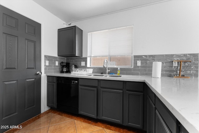 kitchen featuring light countertops, gray cabinetry, decorative backsplash, dishwasher, and a sink