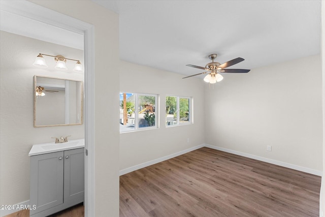 spare room with ceiling fan, sink, and light hardwood / wood-style floors