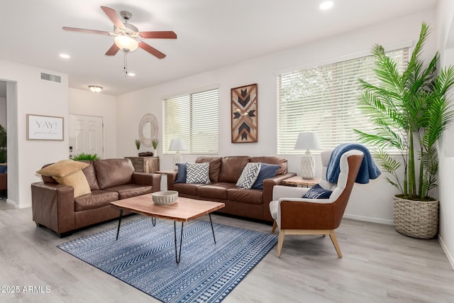 living room with ceiling fan and light wood-type flooring