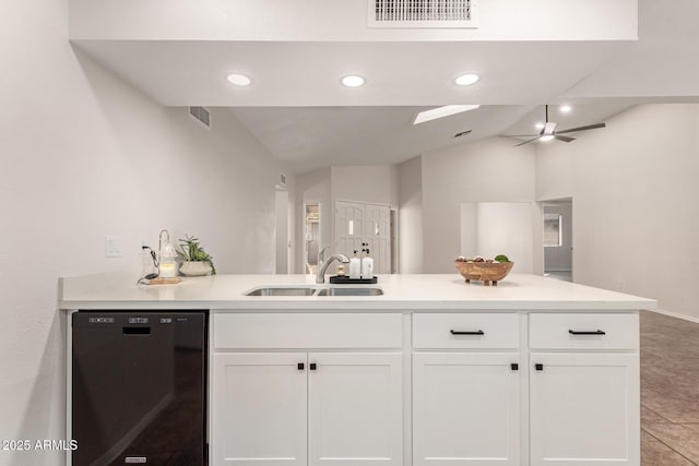 kitchen featuring sink, dishwasher, ceiling fan, white cabinets, and vaulted ceiling