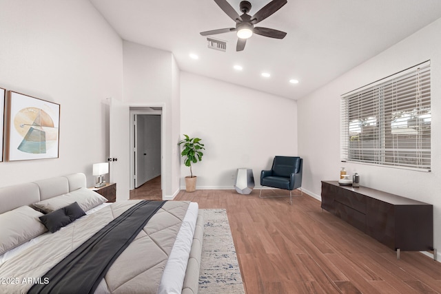 bedroom featuring ceiling fan, wood-type flooring, and vaulted ceiling