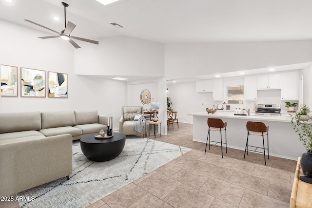 living room featuring high vaulted ceiling and ceiling fan