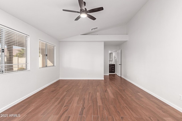 empty room with lofted ceiling, dark wood-type flooring, and ceiling fan