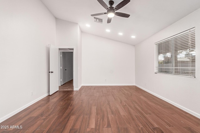 empty room with dark wood-type flooring, ceiling fan, and lofted ceiling