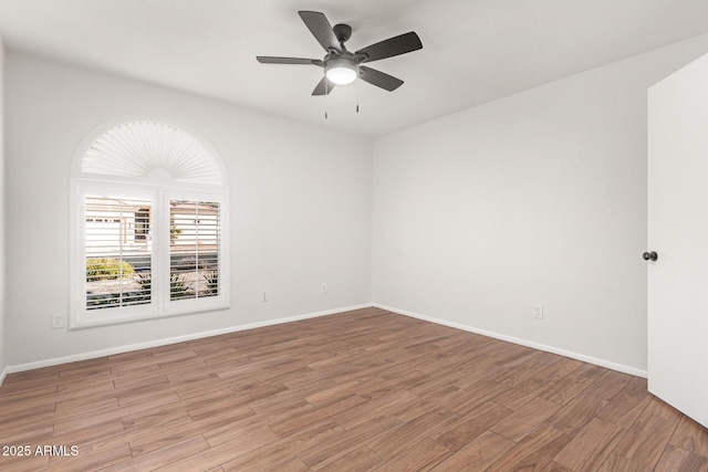 unfurnished room with ceiling fan and light wood-type flooring