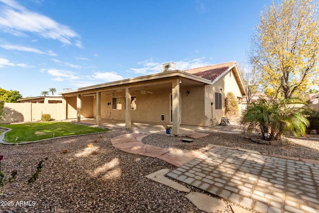 rear view of property featuring a patio and ceiling fan