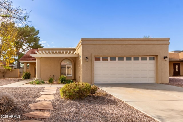 pueblo-style house featuring a garage