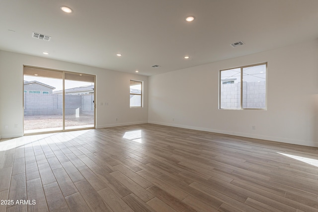 unfurnished room with light wood-type flooring