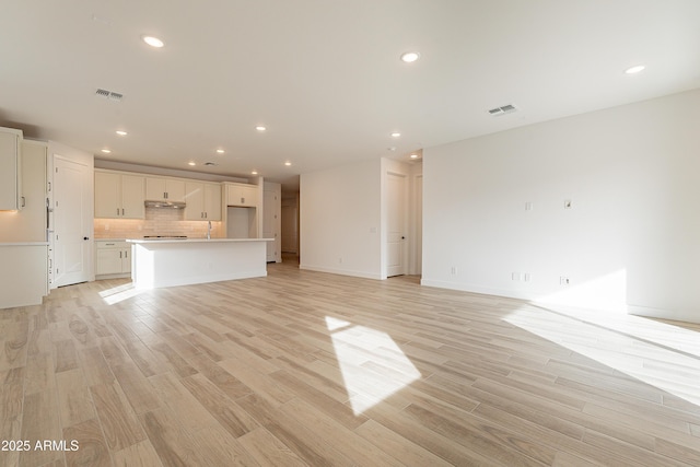 unfurnished living room with light hardwood / wood-style flooring