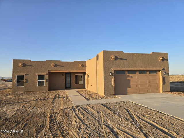 38422 W Buckeye Rd, Tonopah, AZ 85354 - pueblo revival-style home featuring driveway, stucco siding, and an attached garage