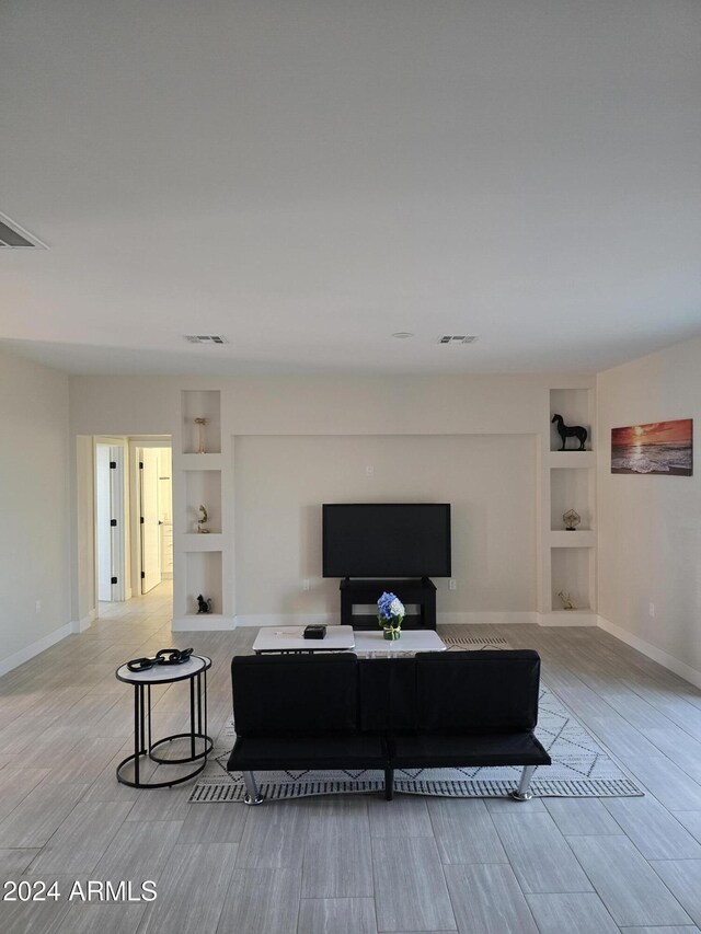 38422 W Buckeye Rd, Tonopah, AZ 85354 - living room featuring baseboards, light wood-type flooring, visible vents, and built in features