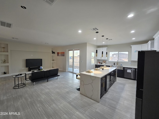 38422 W Buckeye Rd, Tonopah, AZ 85354 - kitchen with visible vents, a healthy amount of sunlight, dishwasher, and freestanding refrigerator