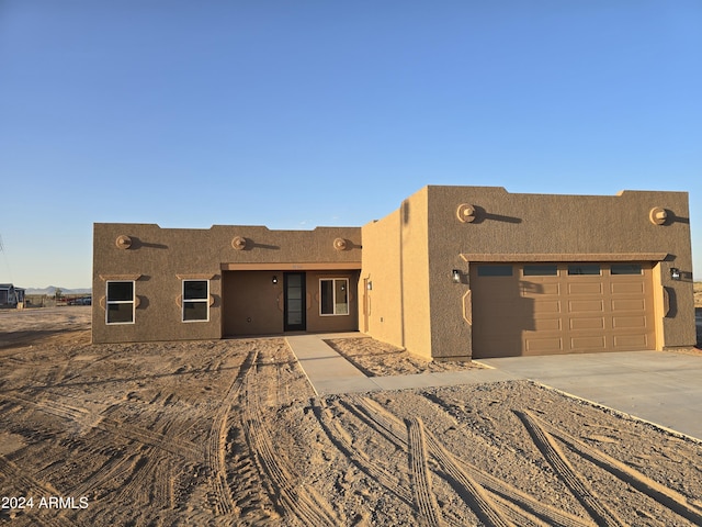 38422 W Buckeye Rd, Tonopah, AZ 85354 - pueblo revival-style home featuring stucco siding, concrete driveway, and a garage