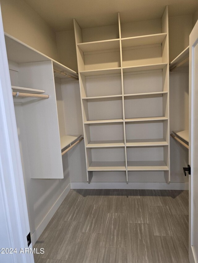 38422 W Buckeye Rd, Tonopah, AZ 85354 - walk in closet featuring dark wood-type flooring
