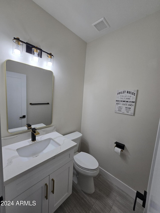 38422 W Buckeye Rd, Tonopah, AZ 85354 - bathroom with toilet, visible vents, vanity, and baseboards