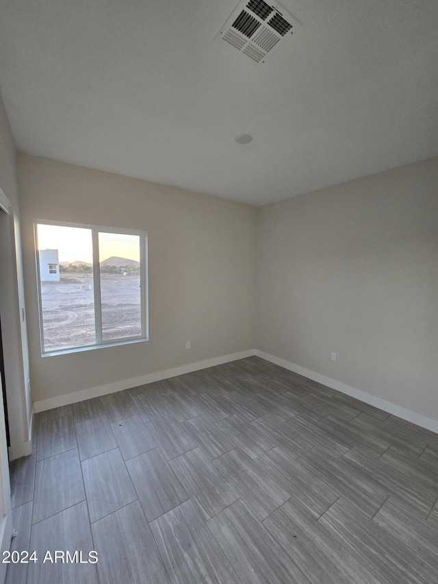 38422 W Buckeye Rd, Tonopah, AZ 85354 - empty room with wood tiled floor, visible vents, and baseboards